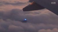老外乘坐飞机 意外拍到泛着蓝光的UFO飞碟躲在云层里的图片